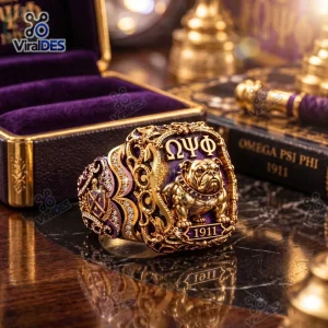 Closeup of an ornate Omega Psi Phi Gold Bulldog Ring featuring purple enamel and Greek letters.