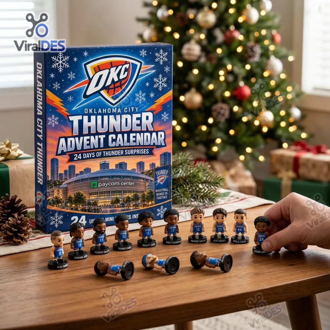 Collector arranging freestanding 3D Oklahoma City Thunder miniature player figurines on a wooden table next to the Paycom Center advent calendar box