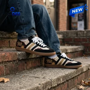 Side view of Greta Van Fleet Adidas Samba Sneakers worn with blue jeans on brick steps.
