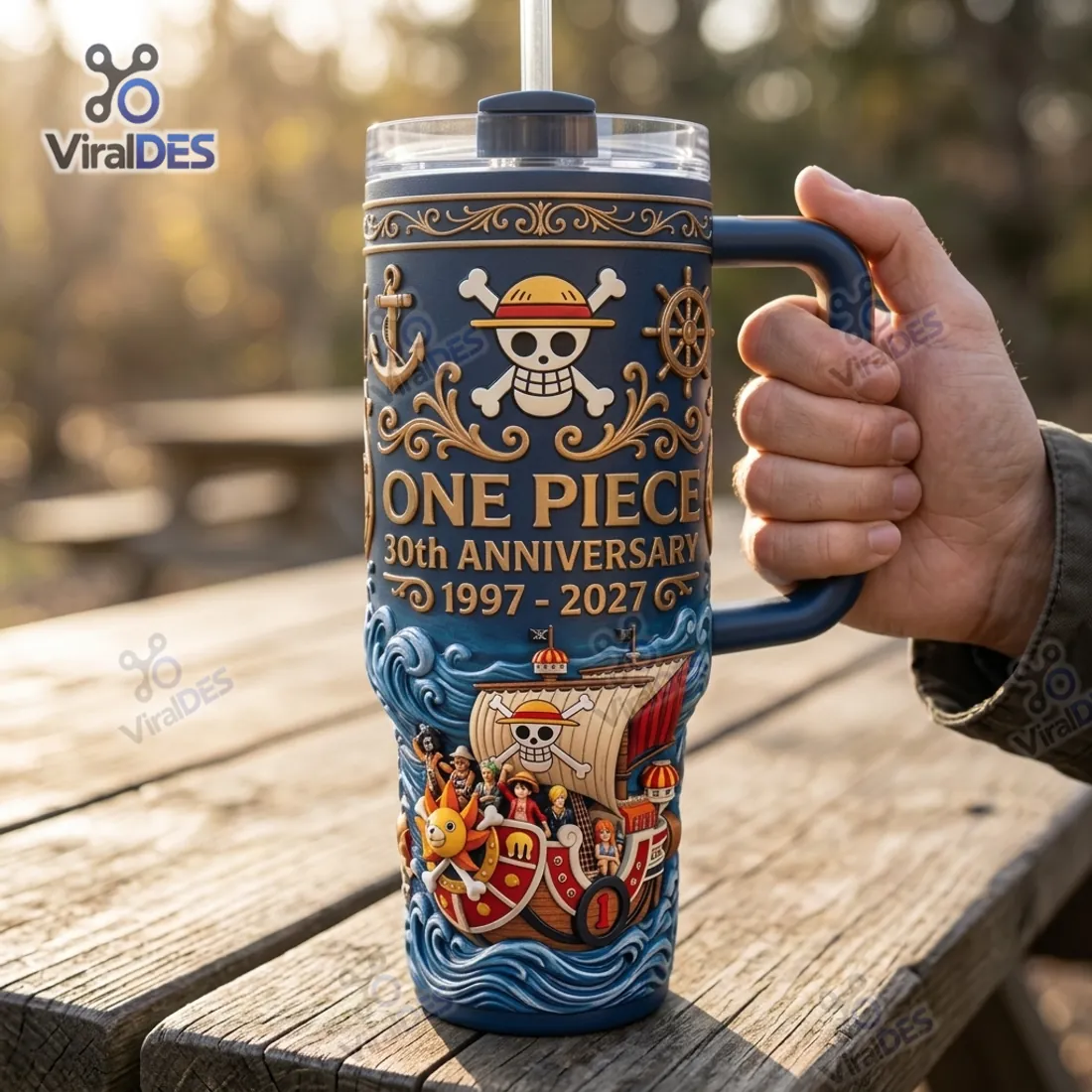 Close-up of the One Piece 30th Anniversary 1997-2027 Handle Tumbler Cup held by its matte navy and gold-accented handle
