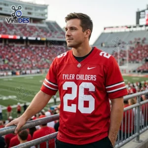 Man wearing red football jersey with number 26 in a stadium setting.