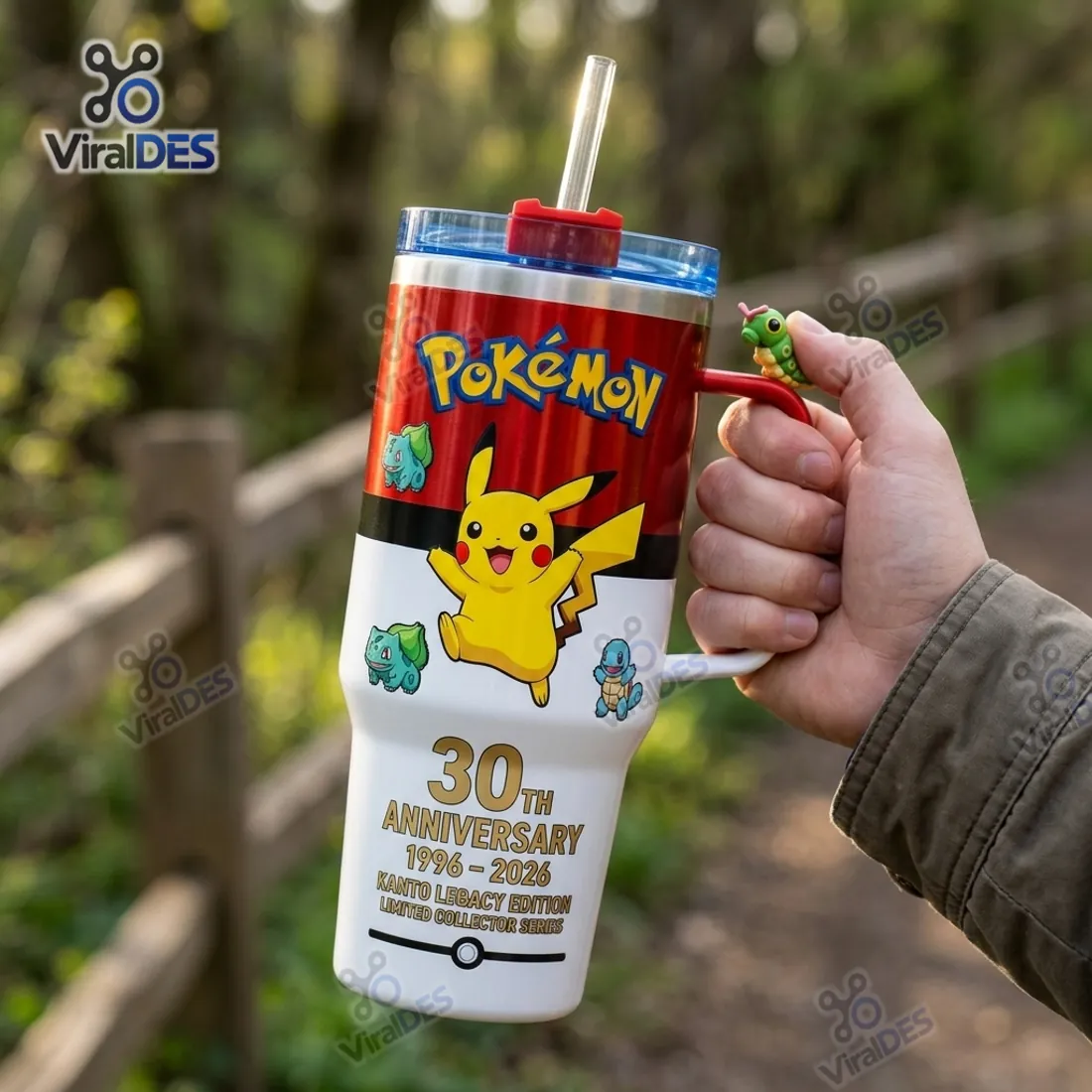 Close-up hand grip on the Pokemon 30th Anniversary 40oz Stanley Tumbler with a 3D green Caterpie perched on the red and white handle