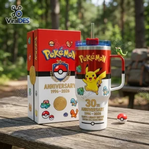 Front view of Pokémon 30th Anniversary 40oz Stanley Tumbler with matching gift box on a wooden picnic table.