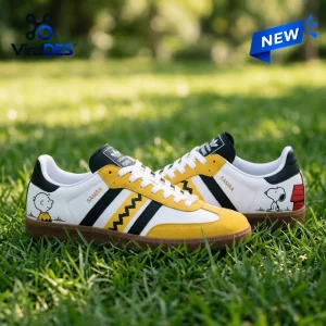 Side view of Peanuts Snoopy Charlie Brown Zigzag Adidas Samba Shoes placed on green grass.