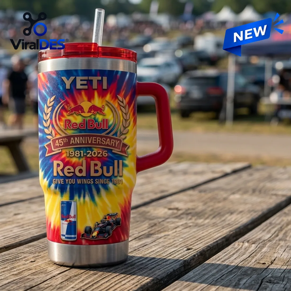 Outdoor picnic table view of the Red Bull 45th Anniversary YETI Handle Tumbler displaying the 1981-2026 laurel crest, energy drink can, and Formula 1 race car graphic