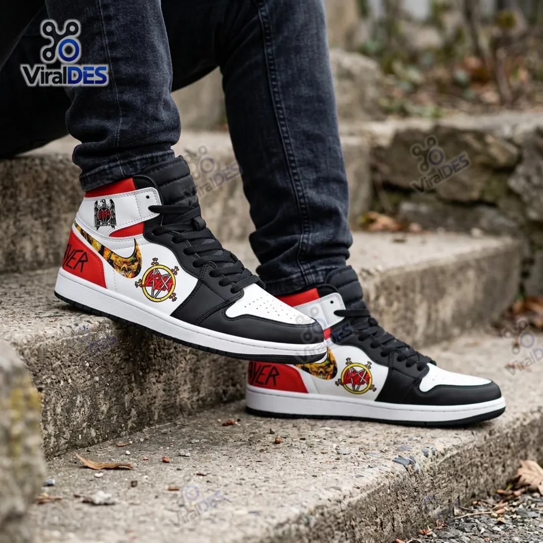 On-foot view of the Slayer Band Air Jordan 1 High Top Sneaker paired with washed black denim jeans on outdoor stone steps