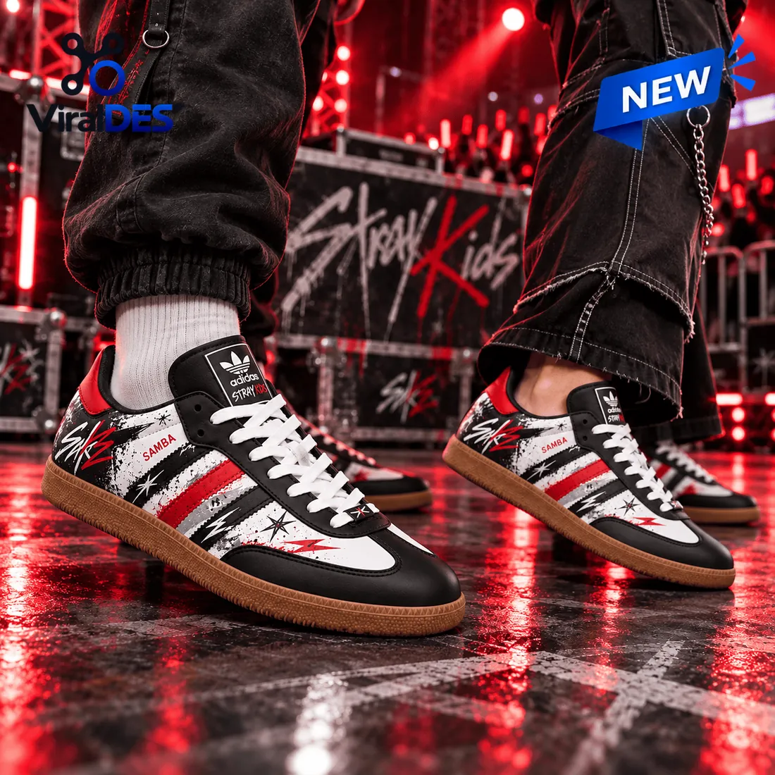 Closeup of Stray Kids Black Red Samba Sneakers worn on stage under red lights.