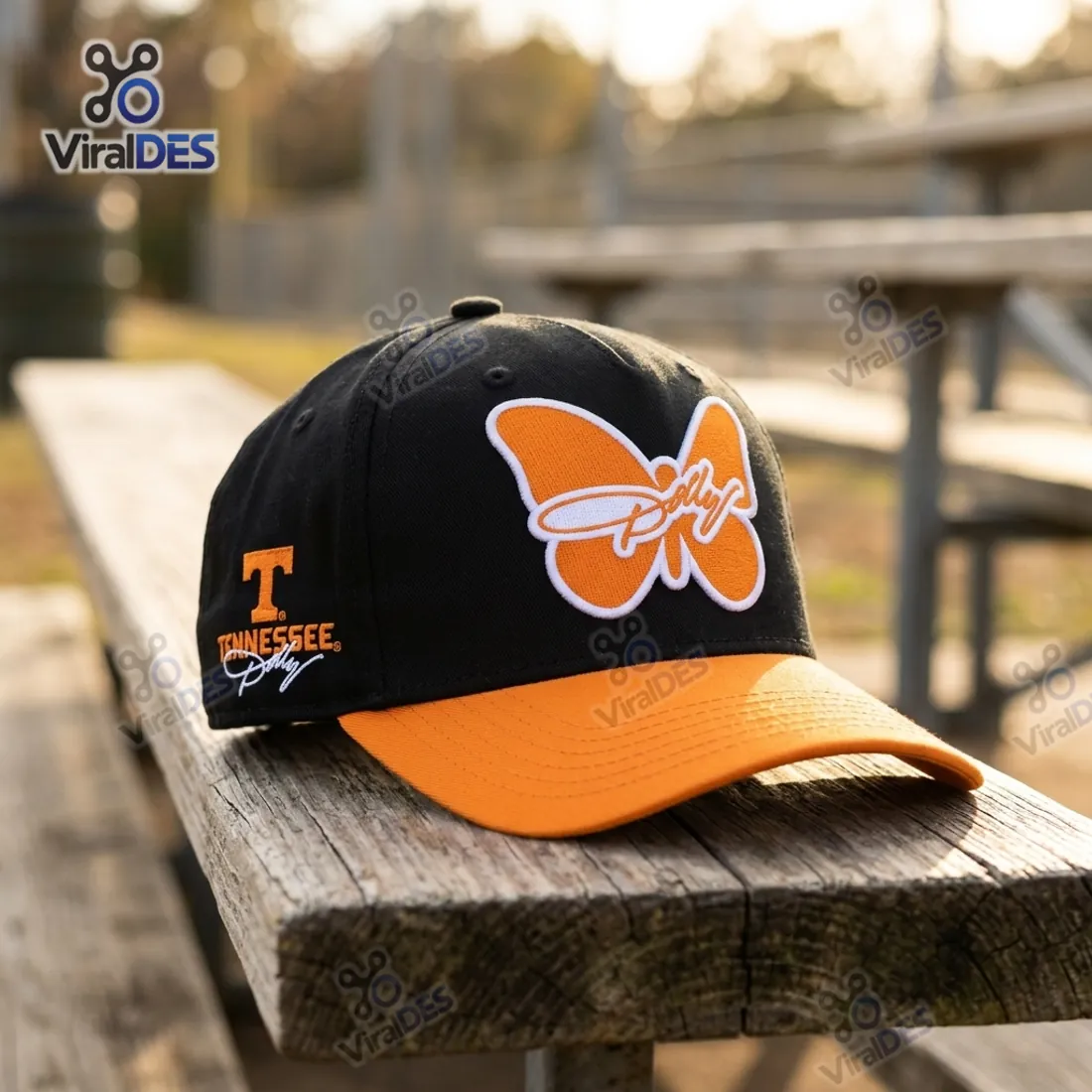 Tennessee Volunteers Dolly Parton Tribute Baseball Cap resting on a weathered wooden park bench displaying the orange butterfly emblem and side Power T logo