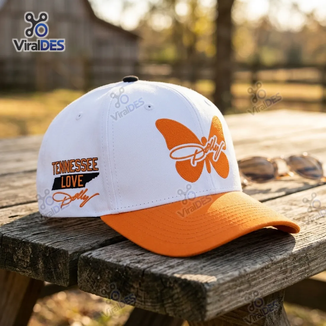 Right profile of the Tennessee Volunteers Dolly Parton Tribute Cap on a wooden picnic table displaying the orange butterfly and Tennessee Love state silhouette
