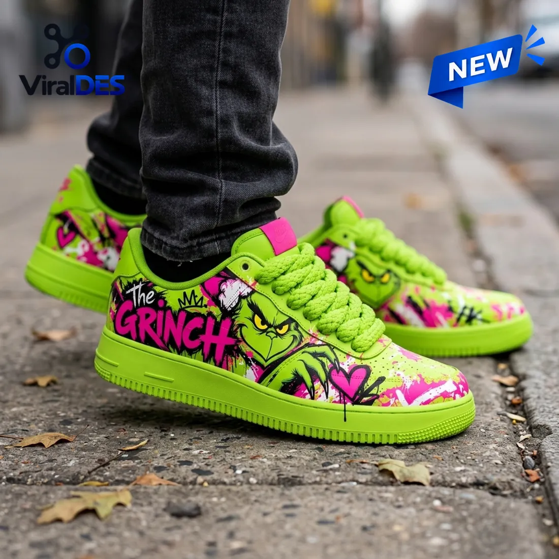 Close-up studio view of The Grinch Neon Green Air Force 1 Shoes highlighting the hot-pink GRINCH graffiti, street-art crown, and dripping heart detail