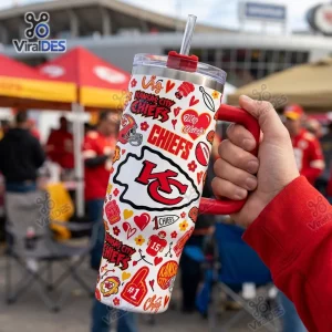 Hand holding a Kansas City Chiefs Football 40oz Tumbler Cup with white background and red football icons.
