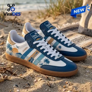 Side view of Kenny Chesney Blue Samba Sneakers with palm tree beach graphics resting on sand.