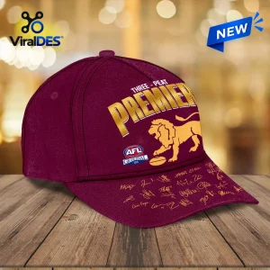 Front view of the Brisbane Lions Three Peat Premiers Maroon Cap with gold lettering.