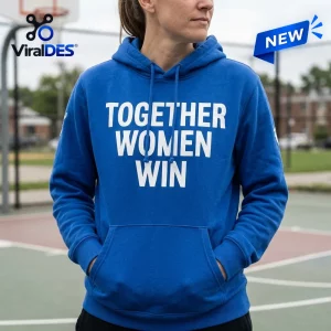 Front view of a person wearing the blue Together Women Win hoodie on an outdoor basketball court.